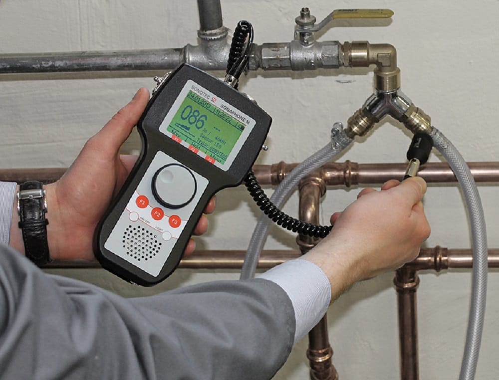 Plumber testing pipes with electronic leak detection equipment in DeLand