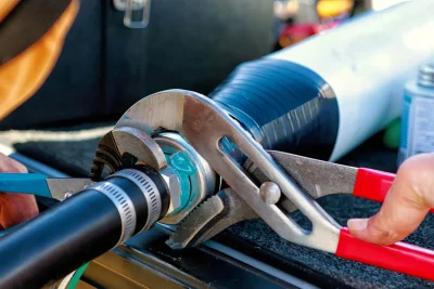 Technician tightening an industrial pipe connection in DeLand