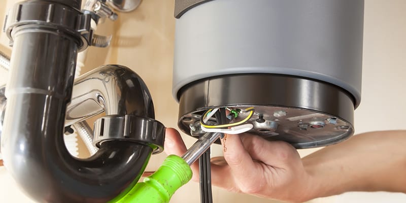 Technician repairing the heating element of a water heater in DeLand