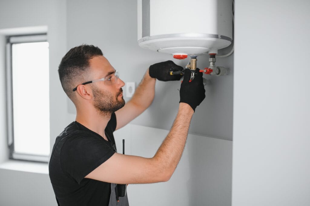 Technician performing water heater maintenance in DeLand