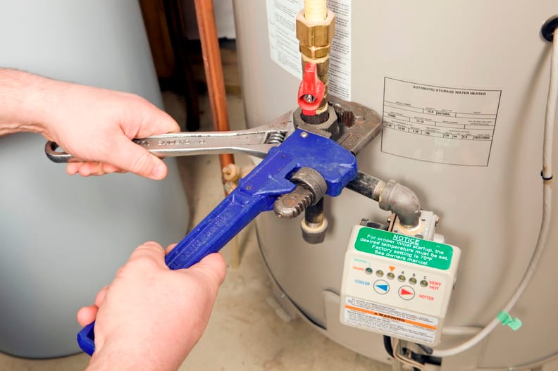 Plumber repairing a water heater valve in DeLand